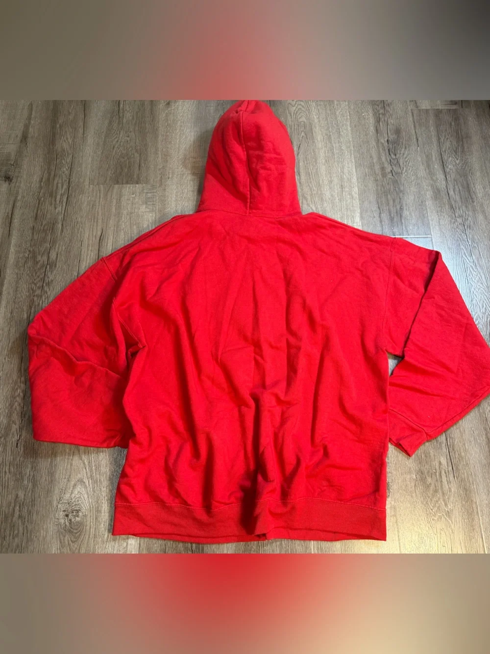 a red sweatshirt featuring a *Home Alone*-style print titled 